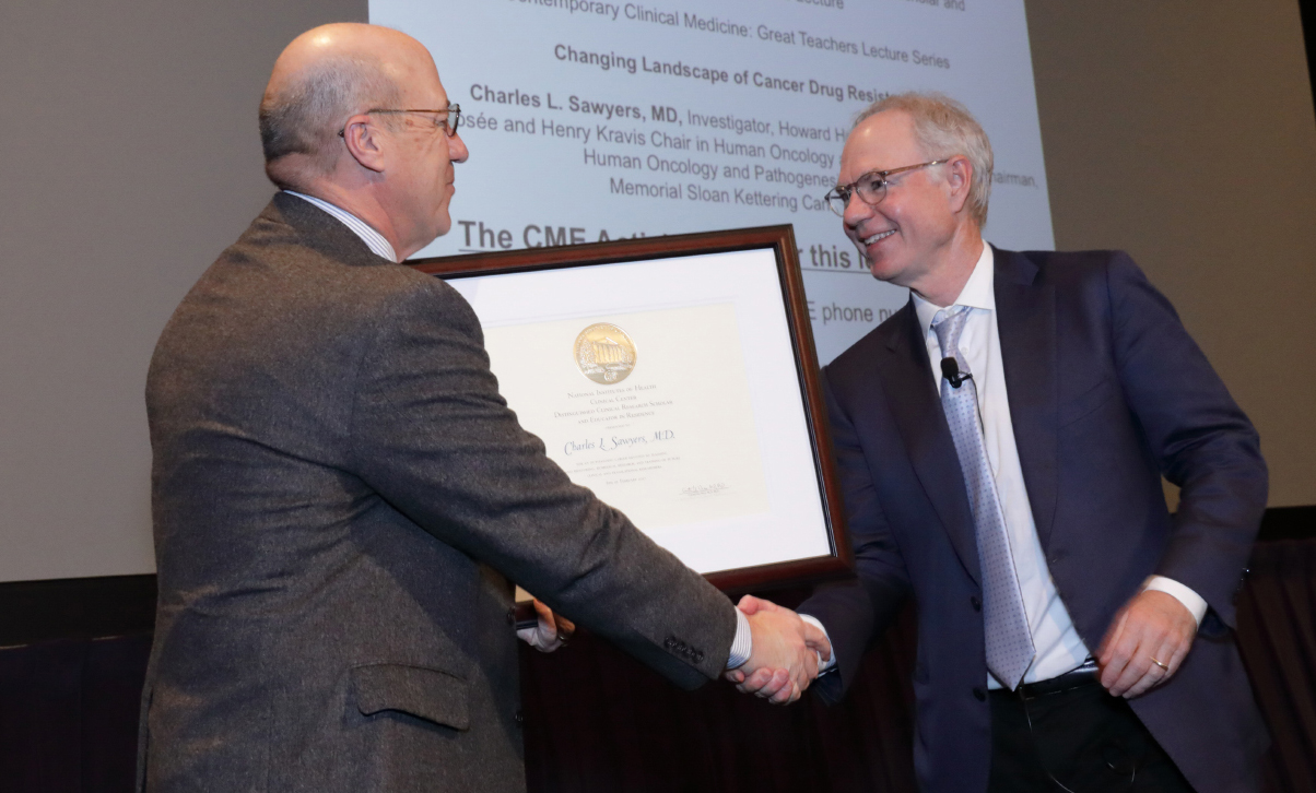 Dr. James K. Gilman presents a certificate of appreciation to Dr. Charles L. Sawyers.