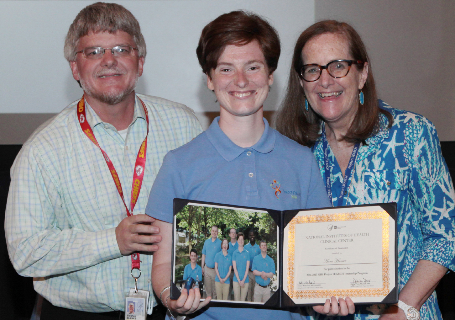 Graduate Annabel Hunter (center) is joined by supporters of the program at NIH: Steve Blanks with SEEC and Lu Merrick with the Ivymount School.