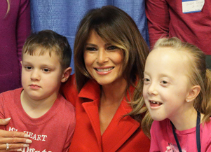 First Lady Melania Trump hugs and poses with children staying at NIH
