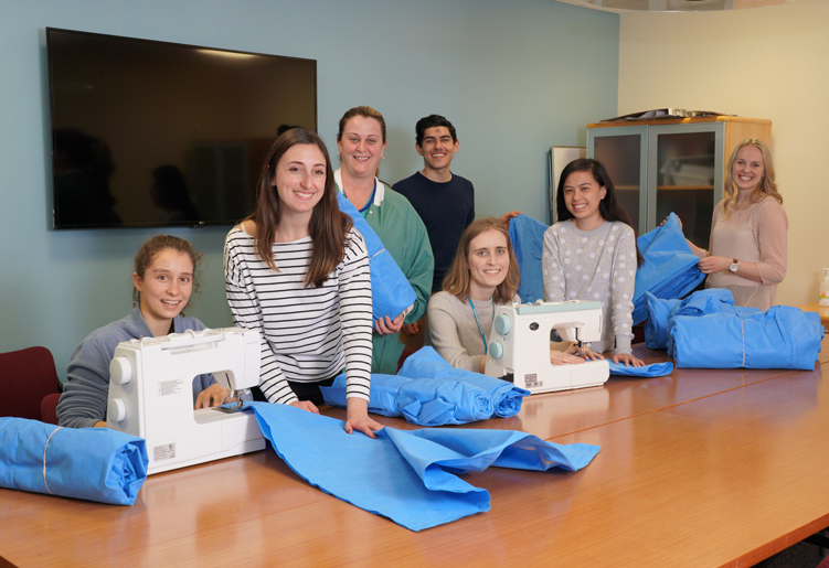 nurses pose with sewing machines