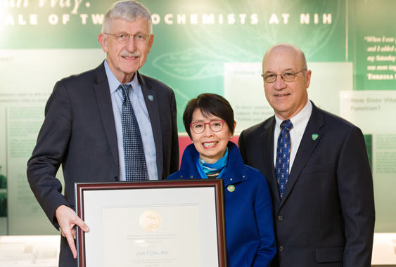 three individuals hold a certificate