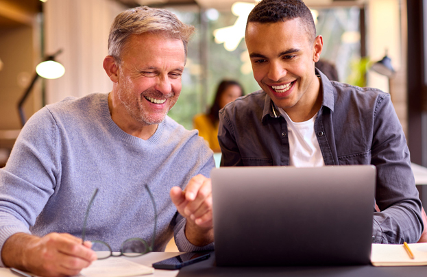 two men viewing a computer screen