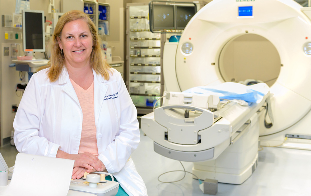 nurse practitioner sits in front of an MRI