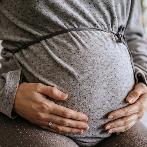 pregnant woman holding belly