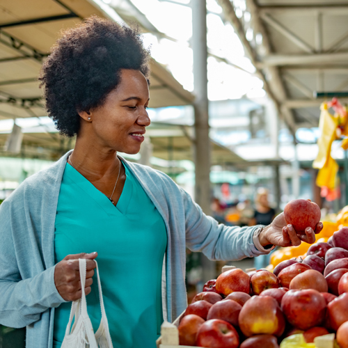 photo of a woman picking fruit