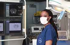 Sheridan Reed standing in front of monitors.