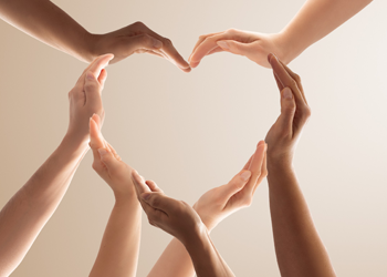 hands grouped together to shape a heart