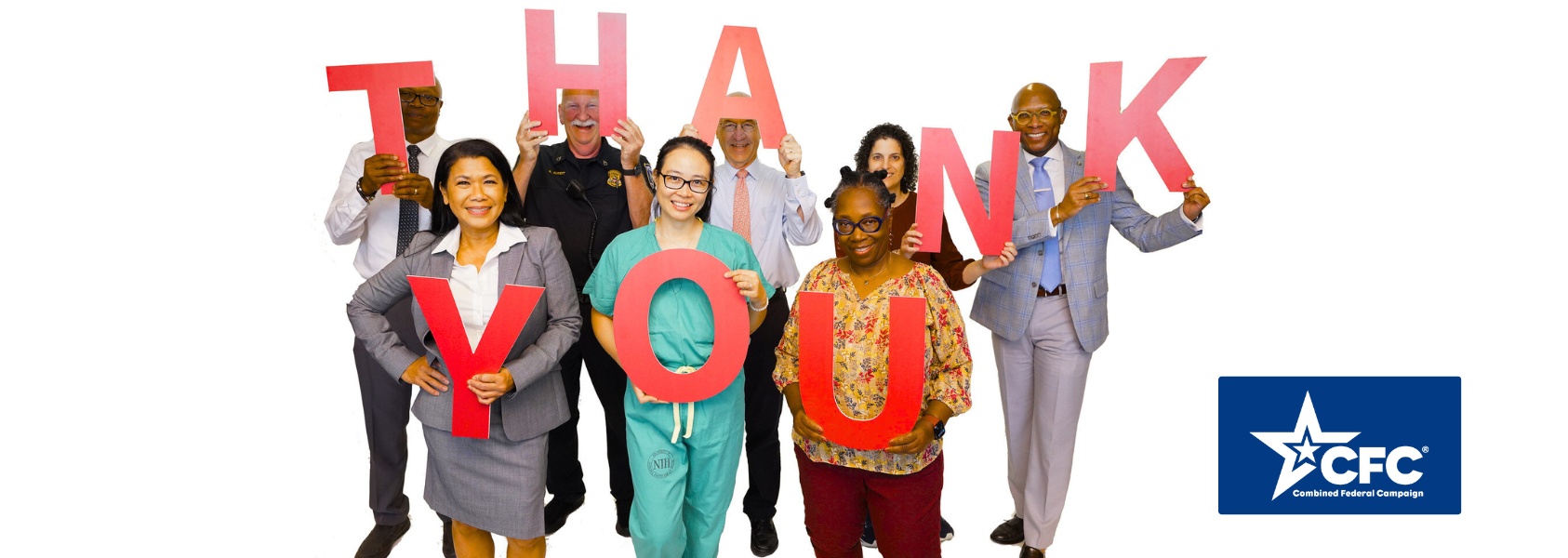 Clinical Center staff hold large letters that spell Thank You