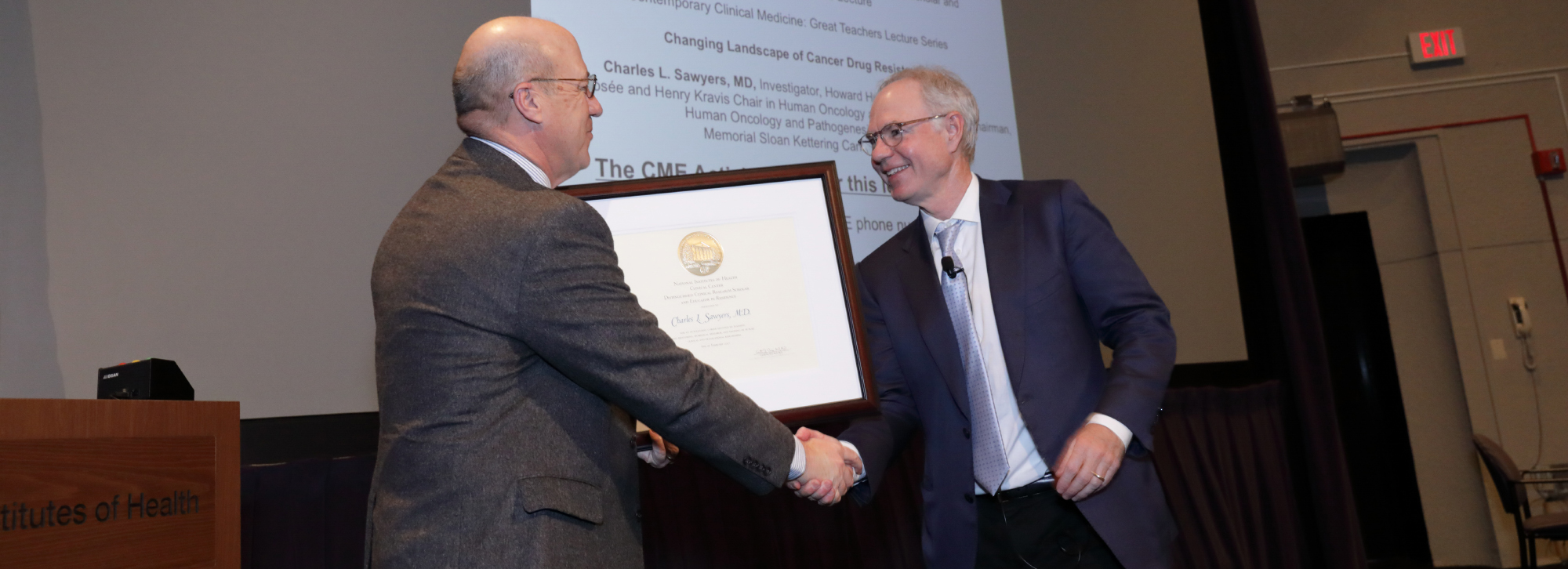 Dr. James K. Gilman presents a certificate of appreciation to Dr. Charles L. Sawyers