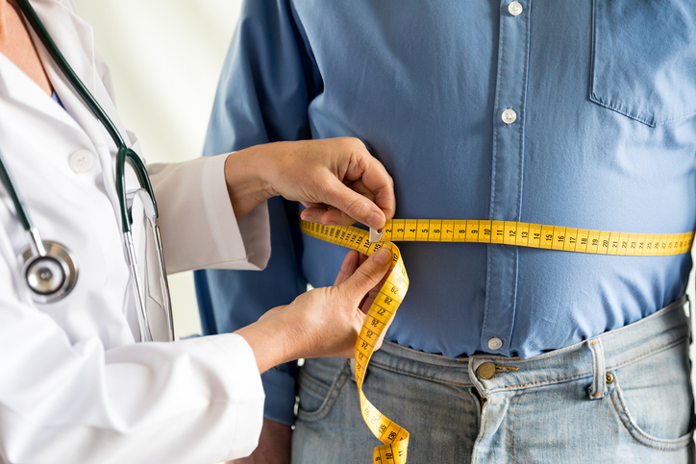 Measuring tape around stomach