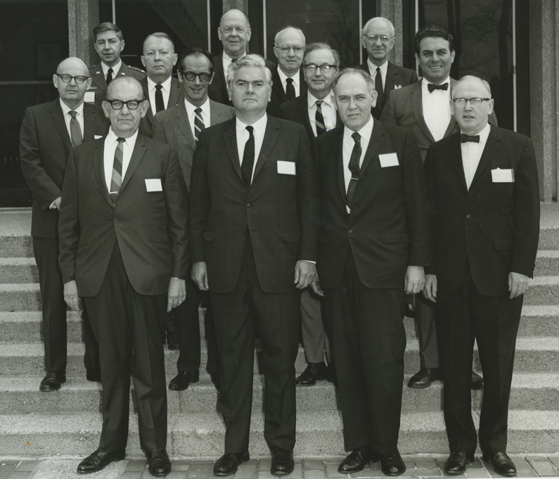 Black and White photo of the first meeting of the National Advisory Eye Council (13 men) gathering on steps