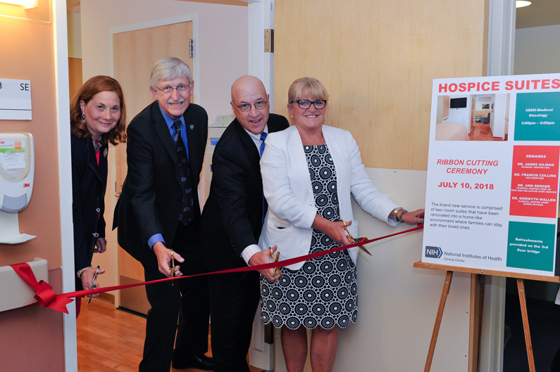 Senior leaders at NIH cut a ribbon opening two hospice suites at the Clinical Center