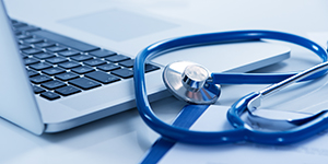 Laptop with stethoscope nearby