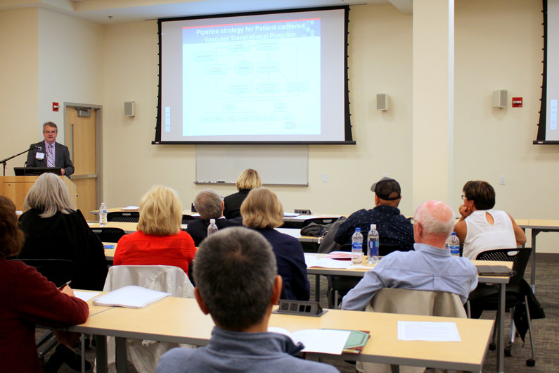 NIH doctor addresses attendees at the symposium