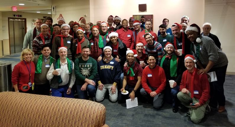 A group of carolers gather on Christmas Eve