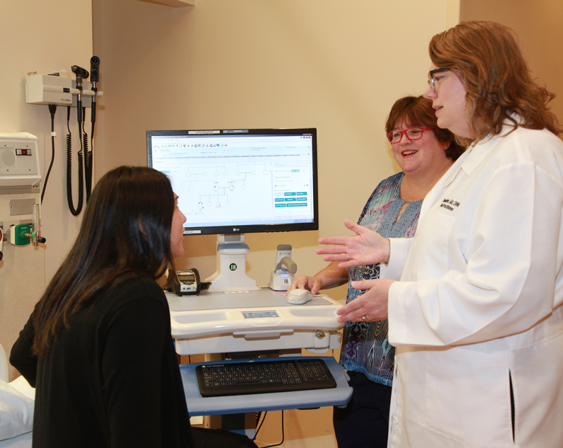 Nurses working on a pedigree diagram within a patient's medical record