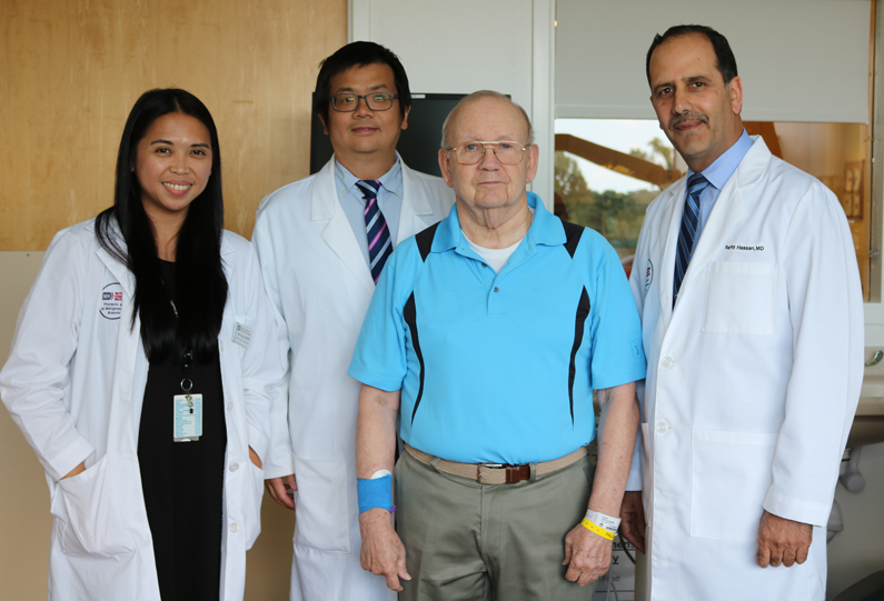 Patient standing with care providers