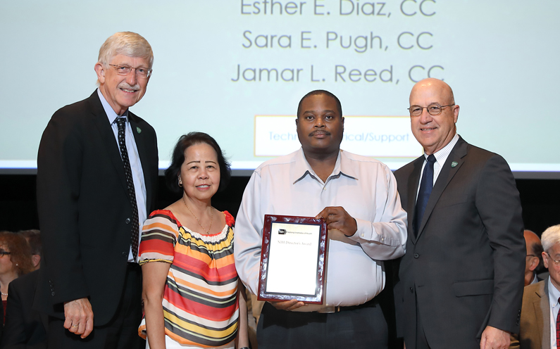 Dr. Francis Collins, Esther E. Diaz, Sean D. Dancy accepting the award for the Nutrition Cook Supervisor Group, and Dr. Jim Gilman