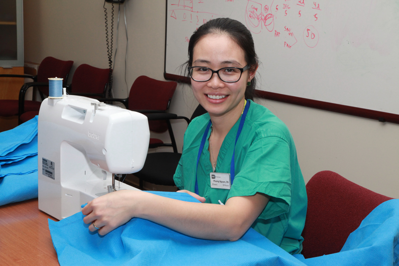 Phuong (Flower) Nguyen using a sewing machine