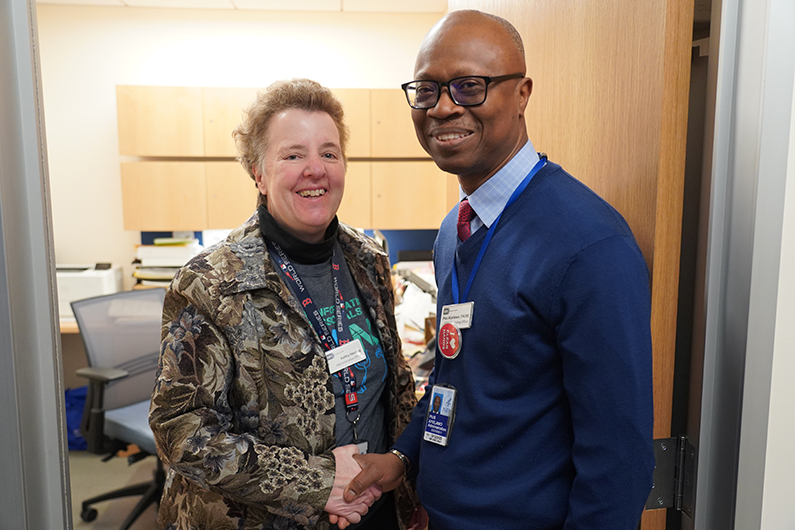 Pius Aiyelawo shakes hands with Kathy Herring