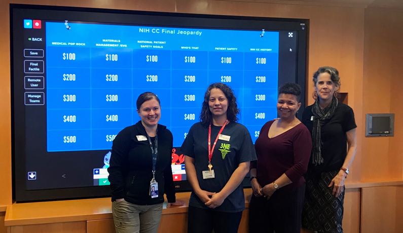 Jeopardy show finalists and host pose for a photo