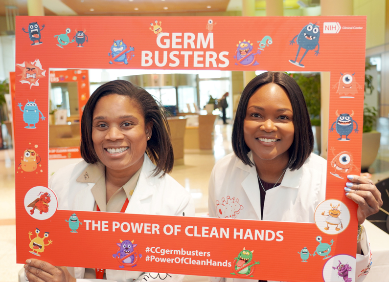 People holding a Hand Hygiene I Love Clean Hands sign