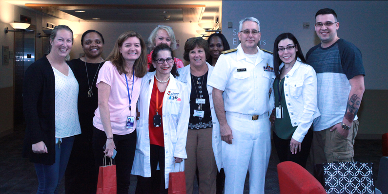 Marissa Amuso and her fiancé Branden Bolivar pose with her transplant team at the NIH Clinical Center