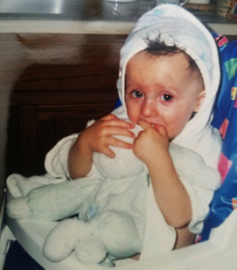 Kayden Reinke, at the age of 2, holding Lammie