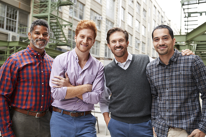 four men smiling