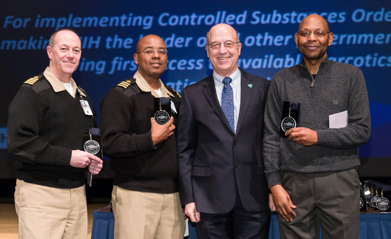 Four men on stage at the awards