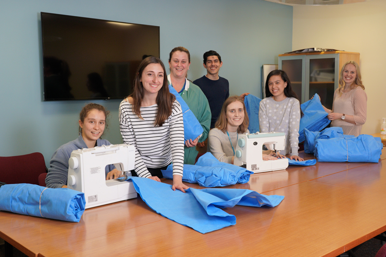 Charlotte Langner, Elizabeth Aliberti, Carrie Wellen, Arman Niknafs, Rosalie Nolen, Celeste Cravalhon and Kathryn Johnston work on sewing blankets