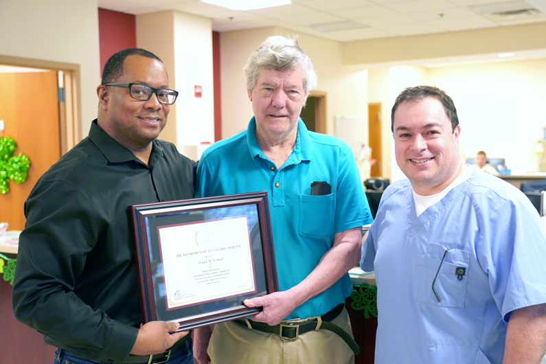 Two males holding appreciation certificate