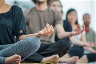 People sitting cross legged and meditating