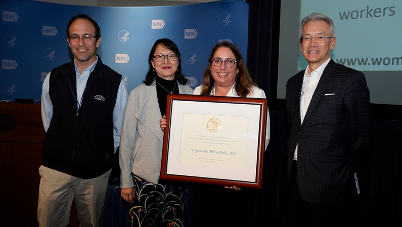 Dr. Samantha Meltzer-Brody holding award