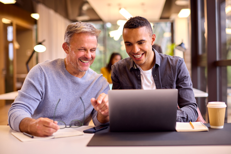 2 men looking at a computer