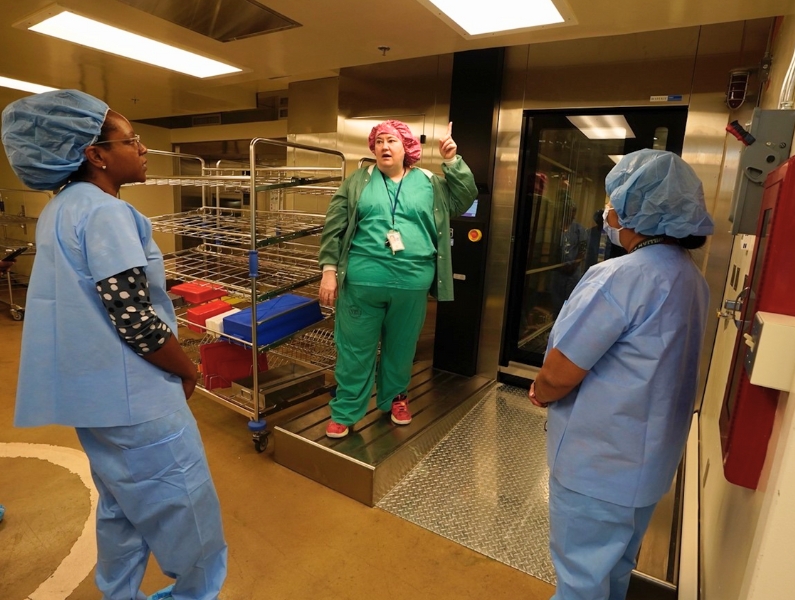 Belinda Avila (center) provides an overview of the rack washer