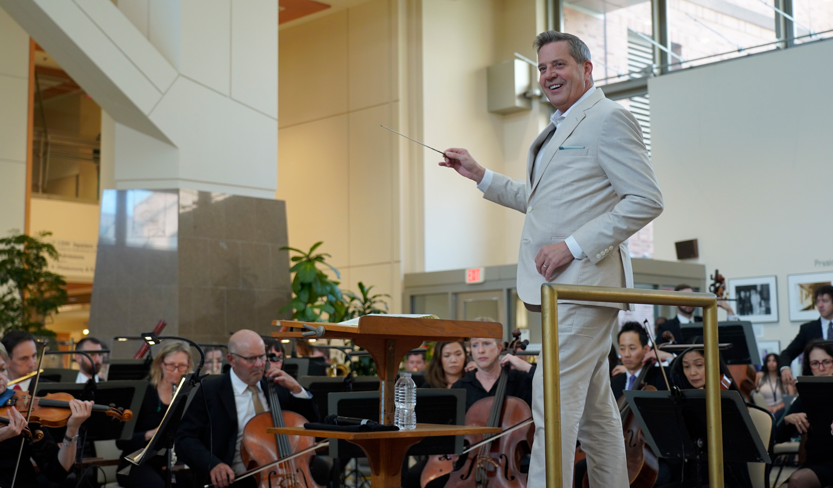 Steven Reineke conducting The National Symphony Orchestra in the NIH Clinical Center Atrium