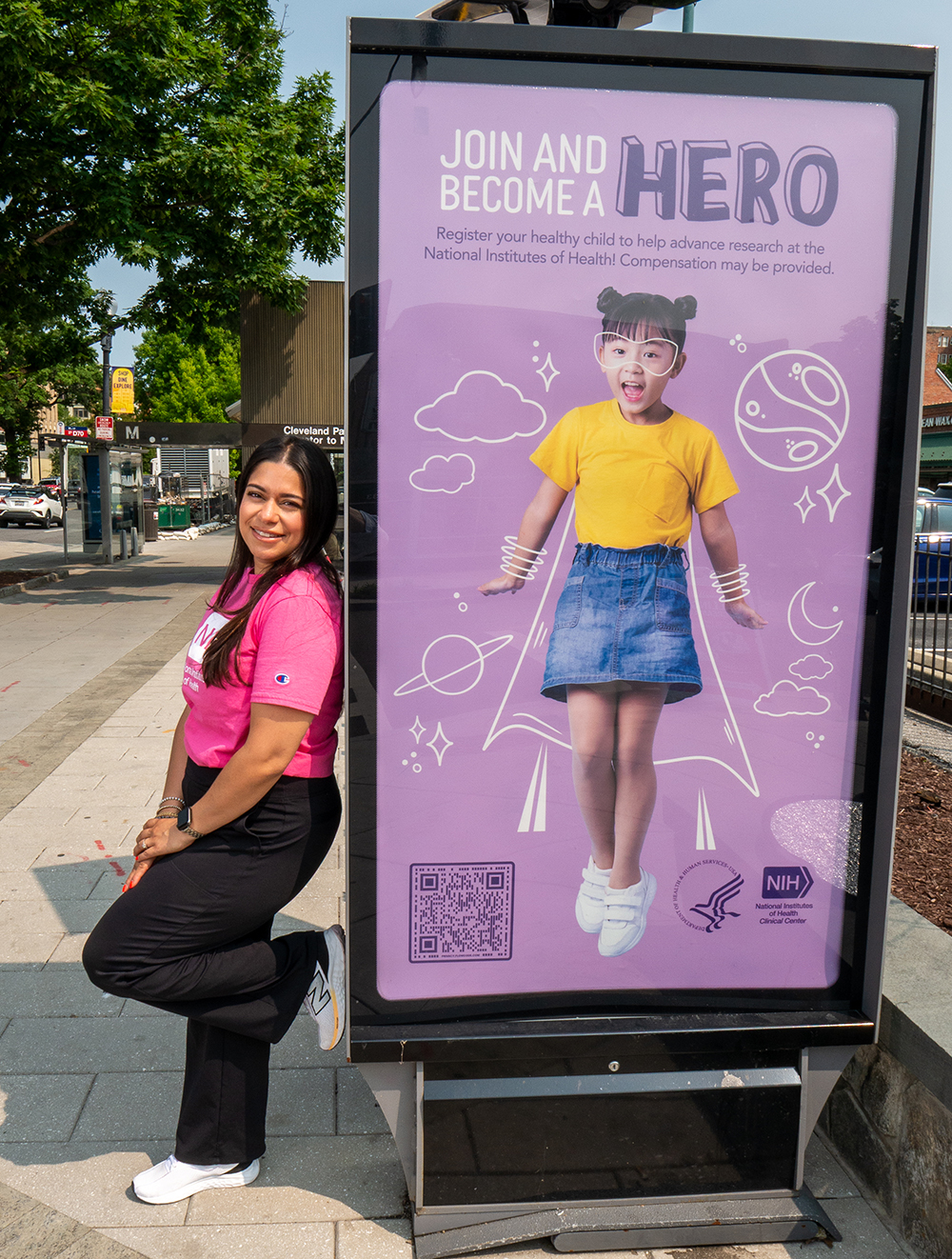 Amanda Anazco leaning against a patient recruitment ad