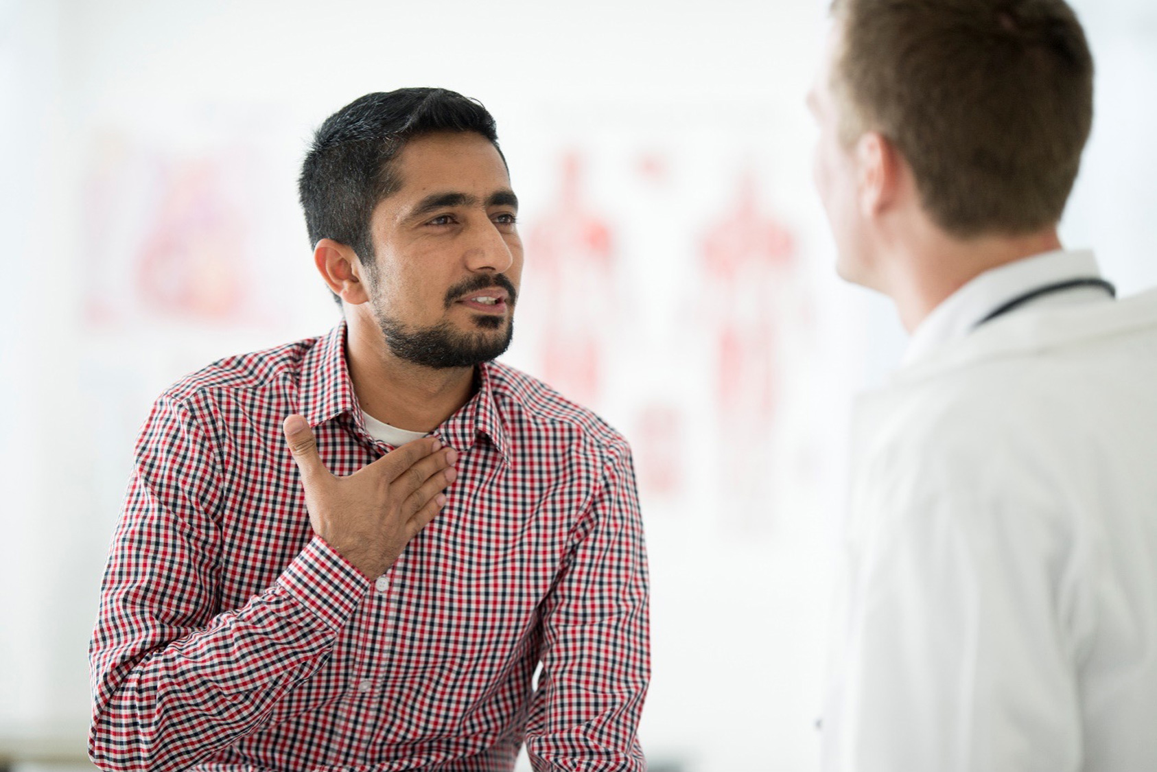 A male patient speaking to his doctor about his chronic sore throat