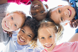 Children smiling in a huddle