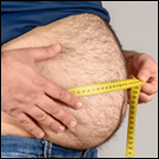 overweight man measuring waist