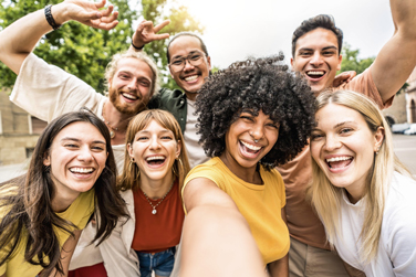 A group of young adult friends smiling while posing for a photo