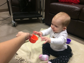 a baby playing with a ball