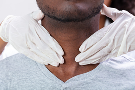 A doctor evaluating a patient's throat and neck