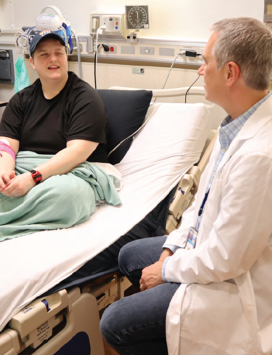 a healthy volunteer smiles at Dr. Hall