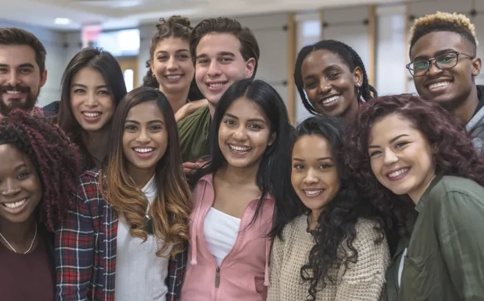 A group of eleven students pose for a photograph as a group.