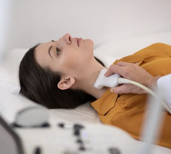 Woman having her thyroid/neck imaged