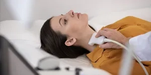 Woman having her thyroid/neck imaged