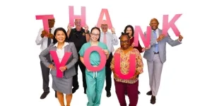 NIH staff hold large letters spelling Thank You