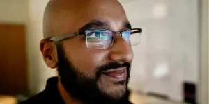 Abhinav Suri with computer screen reflecting in his glasses